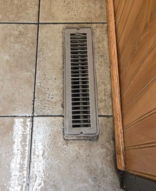 Tile at a floor vent, before