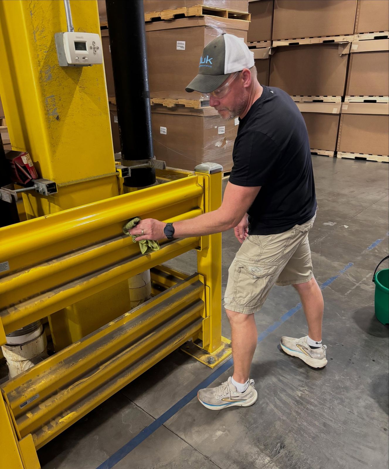 First Impressions tech wiping down warehouse racking